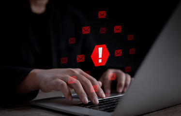 A user receives multiple red alert notifications on laptop, symbolizing email security threats,...