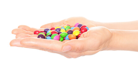 Woman hand holds lot of color candies, isolated on transparent background, fast food concept