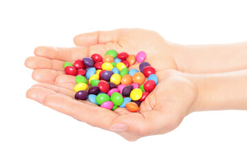 Woman hand holds lot of color candies, isolated on transparent background, fast food concept