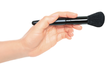 Woman hand holds black cosmetics brush, isolated on transparent background, cosmetics and visage concept