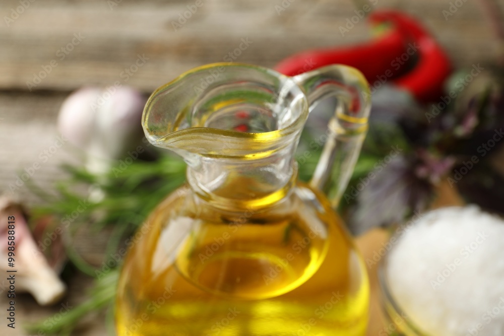 Wall mural cooking oil in jug on blurred background, closeup