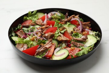 Delicious fresh tuna salad on white marble table, closeup