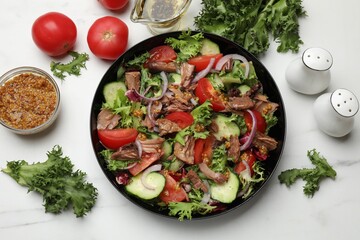 Delicious fresh tuna salad and ingredients on white marble table, top view