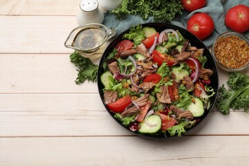 Delicious fresh tuna salad and ingredients on wooden table, top view. Space for text