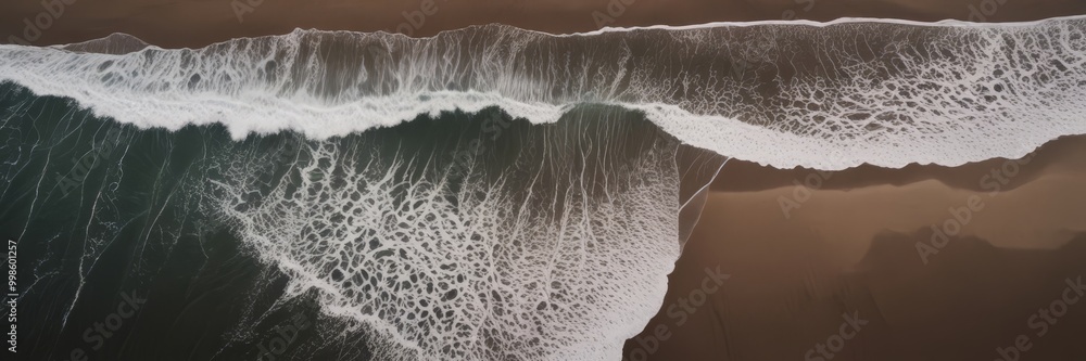 Poster Aerial view beach with waves crashing onto the shore, featuring a brown and white color palette