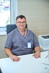 Doctor seated at desk in clinic office