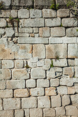 This photograph showcases a close-up view of an old stone wall, likely part of a historic structure in Porto