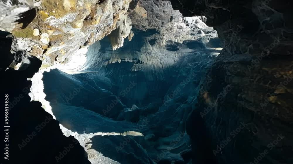 Aufkleber beam of light is bursting through a cave opening, illuminating the magnificent rock formations and s
