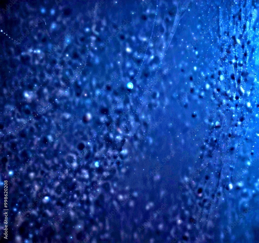 Aufkleber a close-up view dark, textured surface with small, irregularly shaped objects resembling raindrops or snowflakes, creating a sense of depth and movement