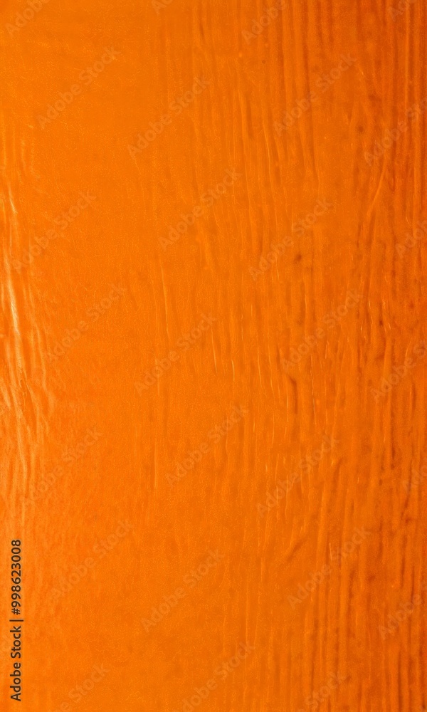 Poster a close-up view textured orange surface, possibly a wooden or fabric material the surface has a roug