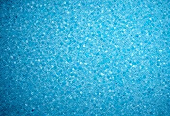 Obraz premium a close-up view textured surface with a blue-green hue, resembling a sponge or foam material