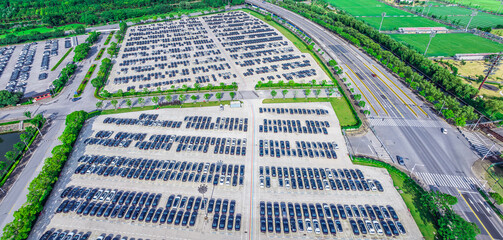 Fototapeta premium Aerial view of large parking lot in modern city
