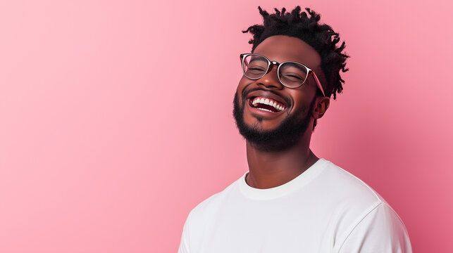 A man laughing nervously, his expression a mix of awkwardness and amusement, framed by a pastel pink background.