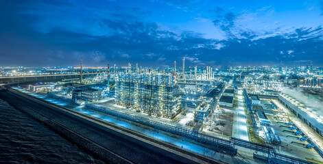 Fototapeta premium Oil refinery chemical plant industrial equipment buildings at night