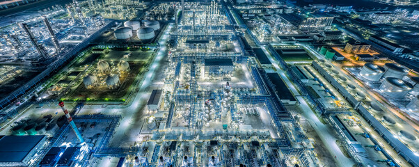 Oil refinery chemical plant industrial equipment buildings at night