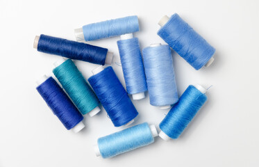 Blue thread spools on white background.
