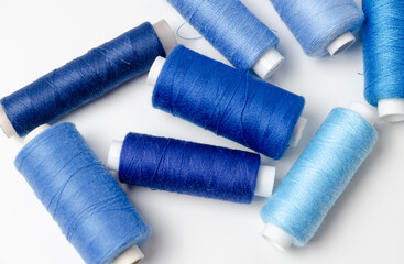 Blue thread spools on white background.