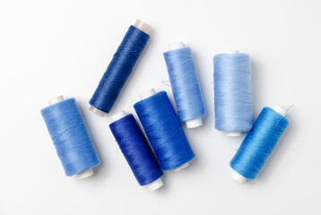 Blue thread spools on white background.
