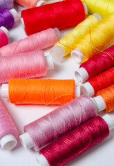 Top view of many colorful thread spools background