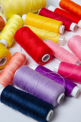 Top view of many colorful thread spools background