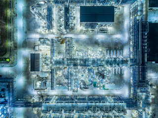 Oil refinery chemical plant industrial equipment buildings at night