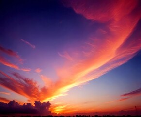 A breathtaking sunset scene with vibrant orange and pink clouds against a deep blue sky, creating a stunning display of nature's beauty