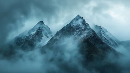 Majestic mountain peaks rise through the mist, a breathtaking view of nature's grandeur.