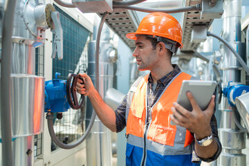 Engineers check and adjust the valves to ensure the proper amount of water flows into the air conditioning pipes.