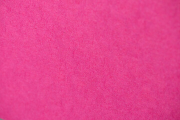 Close-up of natural craft paper texture, showcasing its earthy, raw, and eco-friendly material. Bright magenta colour background.