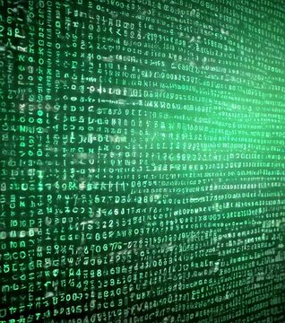 a close-up view computer screen displaying a dense array of green and black characters, resembling a digital data table or a complex code