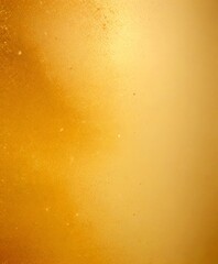 a close-up view textured surface, possibly a glass or a metal, with a warm, golden-yellow hue The surface appears to be slightly reflective, with small specks or