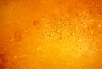Obraz premium a close-up view textured orange surface with small, irregularly shaped dots or bubbles scattered throughout, creating a sense of movement and energy