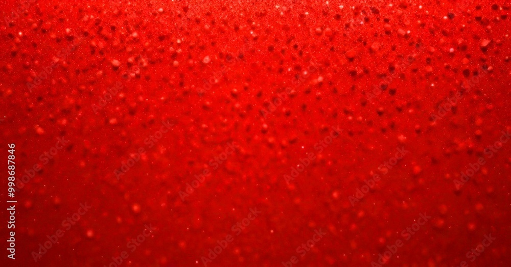 Poster a close-up view red surface with numerous small dots or specks scattered across it, creating a textured and speckled appearance