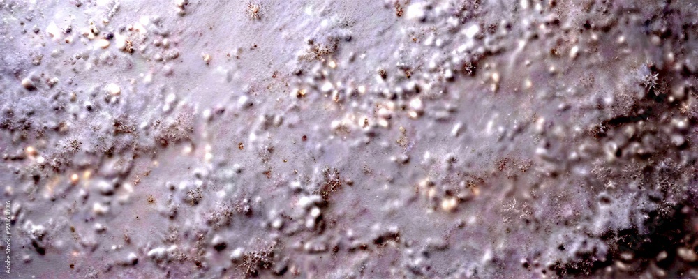Aufkleber A close-up view textured, white surface with small, irregularly shaped specks or particles, resembling snow or a light dusting of powdered sugar