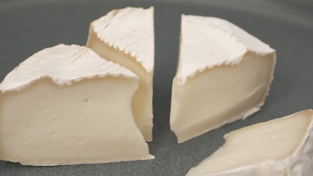 Macro shot of camembert or brie cheese on dish.
