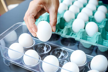 White eggs in refrigerator holder.