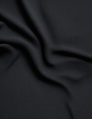 Obraz premium a close-up view black fabric, with the folds and creases creating a textured and dynamic appearance