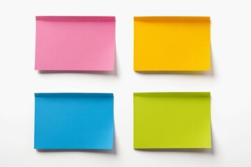 Fototapeta premium four different colored sticky notes are placed on a white surface
