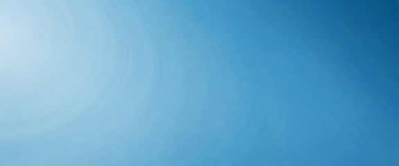 a gradient of blue, transitioning from a lighter shade at the top to a darker one at the bottom The gradient appears to be smooth and continuous, with no discernible objects