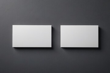Fototapeta premium two square white blank cards on a black wall