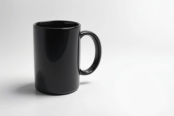 there is a black coffee mug sitting on a white surface