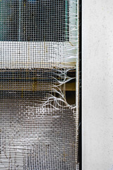 Torn window screen in need of repair