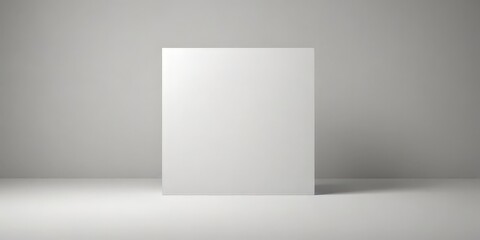 A white rectangular object stands alone against a plain gray background, casting a shadow on the floor below