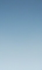 a gradient of blue sky, transitioning from a darker shade at the top to a lighter one at the bottom