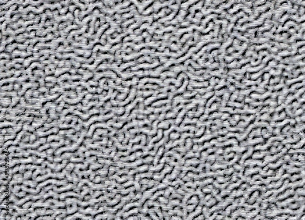 Poster a close-up view of a textured surface, resembling a fuzzy or fuzzy-looking fabric or material. The surface has a grayish-white color and appears to be made of a material that