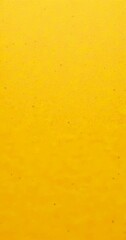 Fototapeta premium a close-up view yellow surface with small, irregularly shaped dots or specks scattered across it, creating a textured and speckled appearance
