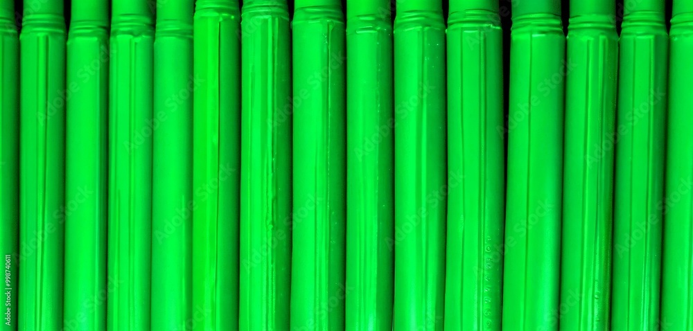 Poster A close-up view series of green cylindrical objects arranged in a row, with a slight overlap and a glossy finish