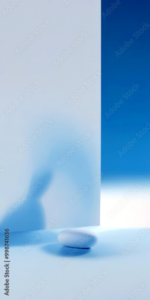 Poster a minimalist scene with a white egg resting on a white surface, set against a gradient background transitioning from white to blue The egg's shadow is