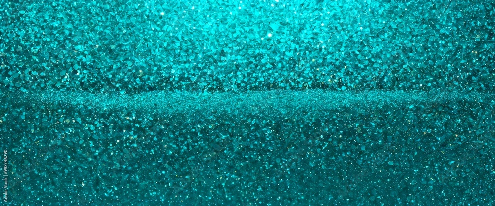 Aufkleber a close-up view of a textured surface with a shimmering, turquoise-colored glitter effect.