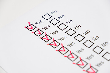 mark Yes checkboxes with red on checklist on white paper